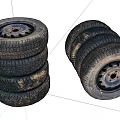 Old Stacked Vehicle Tires With Metal Rims And Worn Tread Patterns