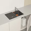 Modern White Kitchen Countertop With Black Cooktop Sink Oranges Open Cabinet And Appliances