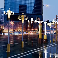 Urban Road Facilities With Modern Street Lamps And Wet Road Surface At Night