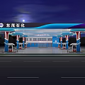 Modern Gas Station Exterior Featuring Blue Wave Canopy And Fuel Pumps At Night