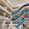 Modern Shopping Mall Interior With Blue Escalators White Columns And Glass Railings