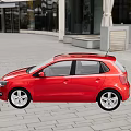Red Volkswagen Small Car Parked On Outdoor Stone Pavement With Glass Building Background