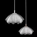 White Pendant Lights With Wavy Design Hanging On Neutral Wall Emitting Soft Glow