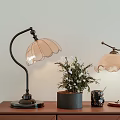 Vintage Table Lamps With Petal Shaped Shades On Wooden Table With Green Plant