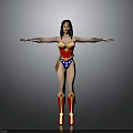 Woman in Wonder Woman Costume with Red and Blue Outfit Arms Outstretched Against Gray Background Golden Accessories and Boots