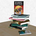 Stack of Assorted Books Including Harry Potter with Colorful Hardcovers on Wooden Table