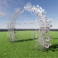 Silver Arched Gate With Intricate Scroll Designs Against Green Grass And Blue Sky