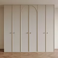 Modern White Wardrobe Featuring Arched Panel Doors Gold Handles and Herringbone Wooden Floor