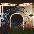 Ornate Decorative Archway With Illuminated Wings Golden Patterns And Surrounding Purple Blue Red Flowers