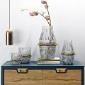 Transparent Glass Decorative Ornament Set With Gold Accents On Blue Cabinet And Books