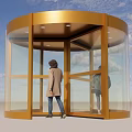 Golden Framed Revolving Door With Transparent Glass Panels And People Entering