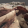Natural Red Sandstone Rock Arch With Surrounding Desert Vegetation And Landscape