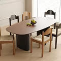Modern Oval Brown Dining Table With Upholstered Chairs And Fruit Bowl On Light Wood Floor
