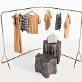 Clothing Rack with Hanging Neutral Tones Plaid Shirts and Silver Handbag on Wooden Stump Bases