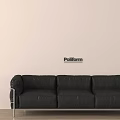 Black Three Seater Sofa With Metal Legs Against Poliform Light Colored Wall