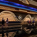 Futuristic Bar Interior Design With Starry Ceiling Curved Wine Racks And Reflective Flooring