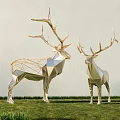 Two Geometric Metal Deer Sculptures As Art Installations On Grass With Light Colored Wall Background