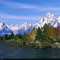 Breathtaking Mountain Lake Scenery With Blue Sky Snow Capped Peaks Colorful Trees And Grassy Shore