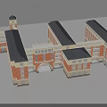 Traditional Red Brick School Building With Clock Tower Archway And Connected Dark Roof Structures