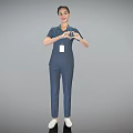 Smiling Woman in Blue Scrubs with ID Badge Making Heart Shape