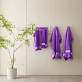 Purple Towels Hanging on Metal Rack with Green Potted Plant Indoor