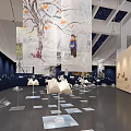 Art Exhibition Space With Large Mural Sculptures And Book Shaped Installations