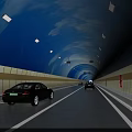 Well Lit Road Facilities in Tunnel with Traffic Lanes and Moving Vehicles