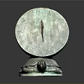 Bronze Sundial With Turtle Base And Roman Numerals On Reflective Surface