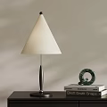 Modern Table Lamp With Conical White Shade Black Pole And Green Decor On Books