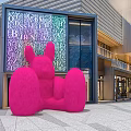Large Pink Rabbit Sculpture In Front Of Modern Commercial Building With Alphabet Art