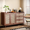 Wooden Sideboard with Rattan Doors Potted Plant Table Lamp Fruit Bowl and Books in Dining Area