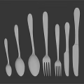 Silver Cutlery With Spoons Forks Knives Neatly Arranged In Various Sizes On Dark Reflective Surface