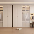 Modern White Wardrobe With Glass Doors Clothes Inside And Dressing Table Mirror On Wooden Floor