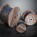 Wooden Cable Reels With Black Cables In Various Sizes On Dark Background