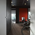 Public Office Space With Red Wall Black Furniture Computer Monitors Chalkboard Wall And Window View