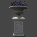 Purple Flowering Plants In Decorative Stone Planter On Pedestal Base