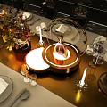 Golden Curved Structure With Illuminated Lines And Central Flame Like Sculpture On Circular Platform