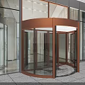 Modern Building Entrance With Bronze Revolving Door And Glass Curtain Wall
