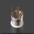Everyday Household White Cup With Black Floral Patterns Holding Cinnamon Sticks