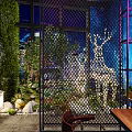 Modern Bar Interior Design With Green Plants Hanging Lights Neon Accents And Wine Racks