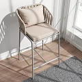 Modern Leisure Chair With Woven Armrests Padded Seat And Silver Metal Frame By Window Natural Light