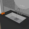 Stylish Kitchen Sink with Faucet Running Water on Black Countertop Near Oranges and Gray Wall