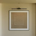 Wall Mounted Abstract Painting With Textural Pattern In Black Frame And Warm Interior Accents
