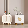White Bedside Tables With Gold Accents And Decorative Plants On Top Surface