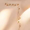 Elegant Beaded Wall Light With Gold And White Pearls For Ambient Interior Glow