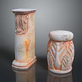 Two Decorative Stone Columns With Carved Leaf Motifs And Orange White Weathered Texture