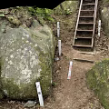 Metal Staircase In Natural Setting With Rock Walls Green Plants And Dirt Ground