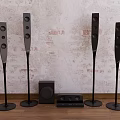 Stylish Home Audio System With Tall Floor Standing Speakers Subwoofer And Brick Wall Design