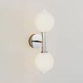 Modern Unique Wall Lamp With Two Spherical Lampshades And Metal Bracket Mounted On Light Wall