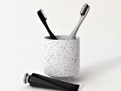 Stylish Bathroom Accessories Set With White Speckled Cup Black Gray Toothbrushes And Black Toothpaste Tube 3d model